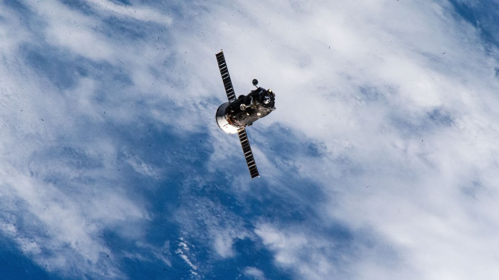 The Progress 87 cargo craft, packed with trash and discarded gear, departs the International Space Station following a six-month resupply mission docked to the Zvezda service module's rear port.