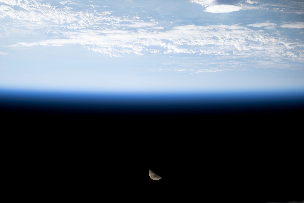 The First Quarter Moon is pictured above Earth's horizon from the International Space Station as it orbited 263 miles above the English Channel in between France and England.