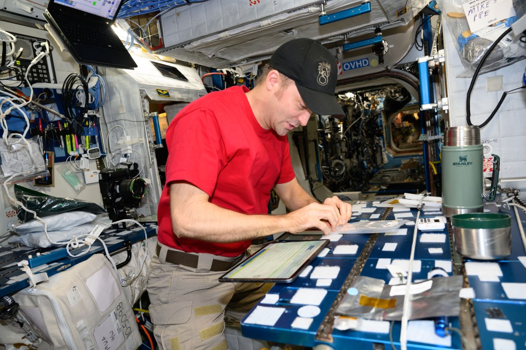 NASA astronaut and Expedition 71 Flight Engineer Matthew Dominick mixes and prepares small bags of simulated lunar cement for a 24-hour incubation period inside a thermos can. Afterward, the samples were stowed for several more weeks of hardening at ambient temperatures on the International Space Station. The space-created cement samples will be returned to Earth for scientists to analyze their microstructure and mechanical strength.