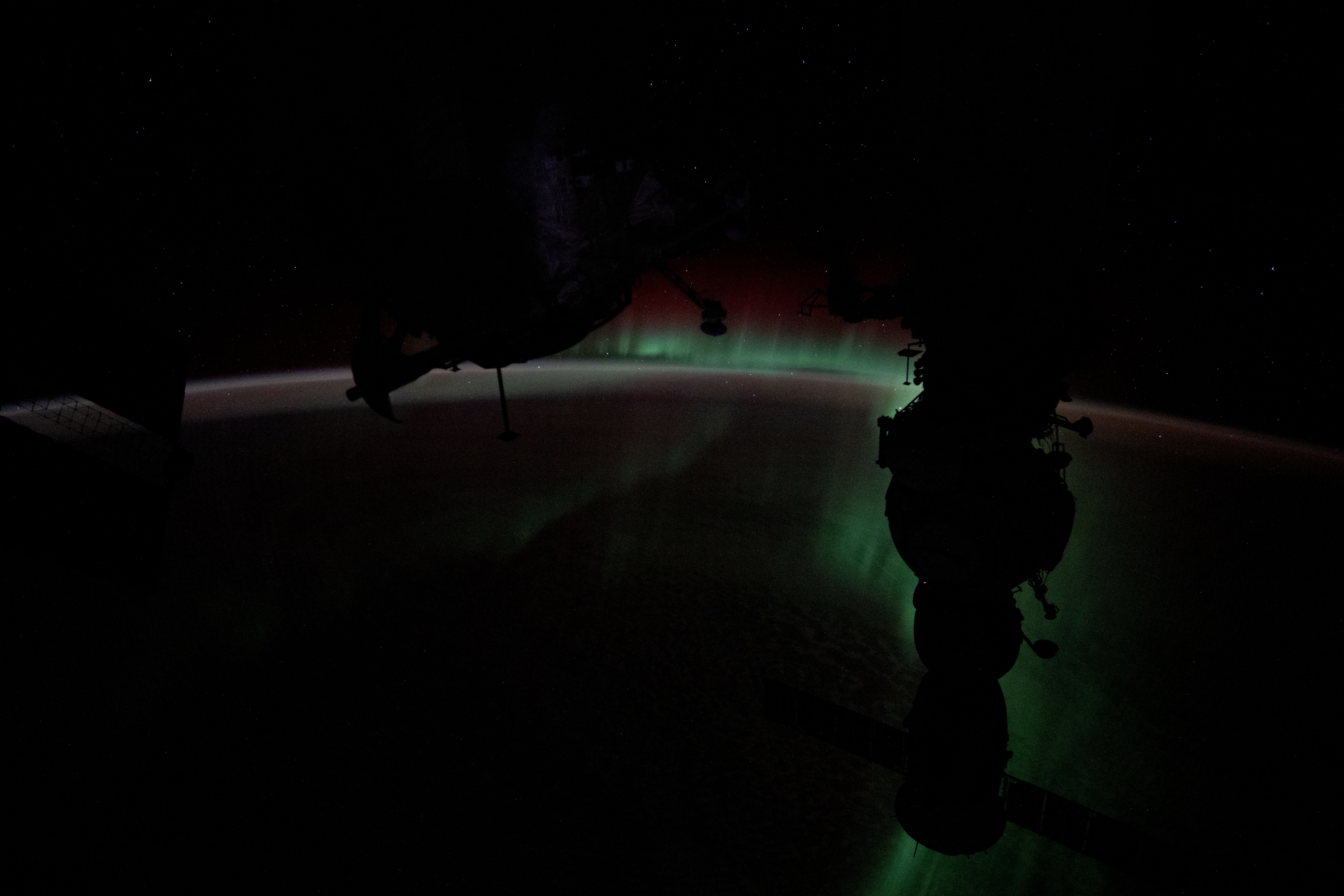 The Aurora Australis silhouettes the Soyuz MS-25 crew ship in this photograph from the International Space Station as it soared 272 miles above the Indian Ocean halfway between Australia and Antarctica.