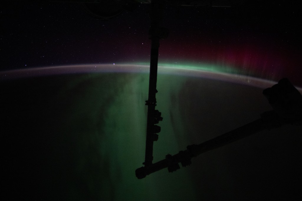 The Aurora Australis silhouettes the Canadarm2 robotic arm in this photograph from the International Space Station as it soared 272 miles above the Indian Ocean halfway between Australia and Antarctica.