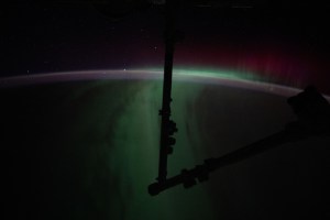 The Aurora Australis silhouettes the Canadarm2 robotic arm in this photograph from the International Space Station as it soared 272 miles above the Indian Ocean halfway between Australia and Antarctica.