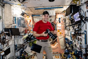 NASA astronaut and Expedition 71 Flight Engineer Matthew Dominick smiles for a portrait during photography duties aboard the International Space Station's Destiny laboratory.