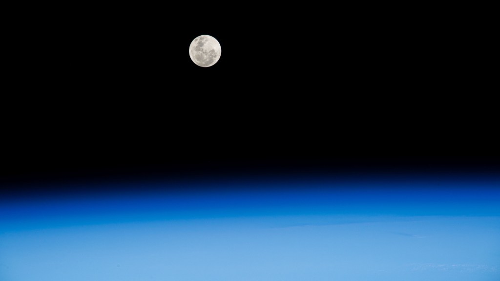 The Full Moon pictured above Earth's horizon as the International Space Station soared 262 miles above the Atlantic Ocean off the coast of South Africa northwest of Cape Town.