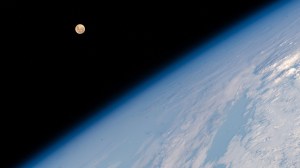 The Full Moon pictured above Earth's horizon as the International Space Station soared 262 miles above the Indian Ocean south of the African island nation of Madagascar.