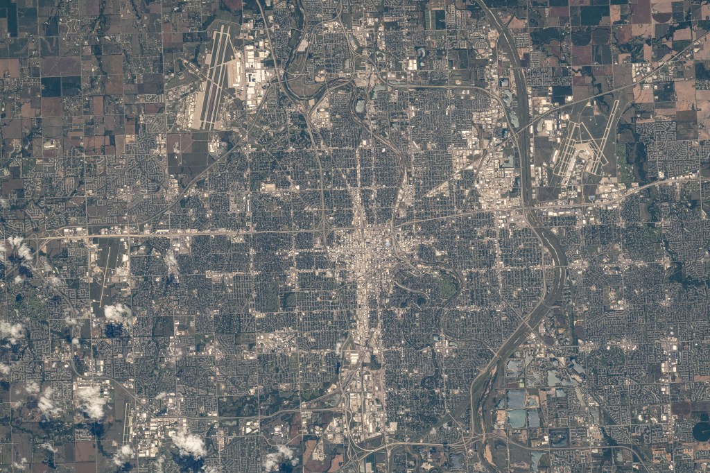 Wichita, Kansas, a city with a population of nearly 400,000, with McConnell Air Force Base just outside the city limits (top left) and hosting the Dwight D. Eisenhower National Airport (upper right), is photographed from the International Space Station as it orbited 260 miles above.