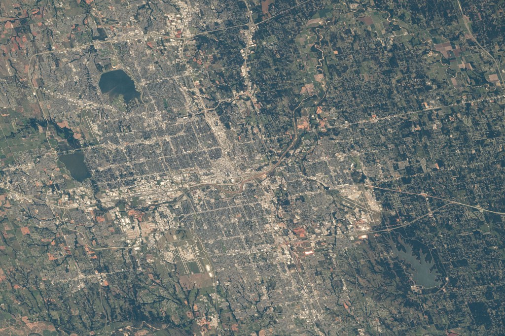 Oklahoma City, the capital of Oklahoma with a population of over 680,000, is pictured from the International Space Station as it orbited 259 miles above. At lower right, near Lake Stanley Draper is Tinker Air Force Base named in honor of Major General Clarence L. Tinker, the first Native American major general.