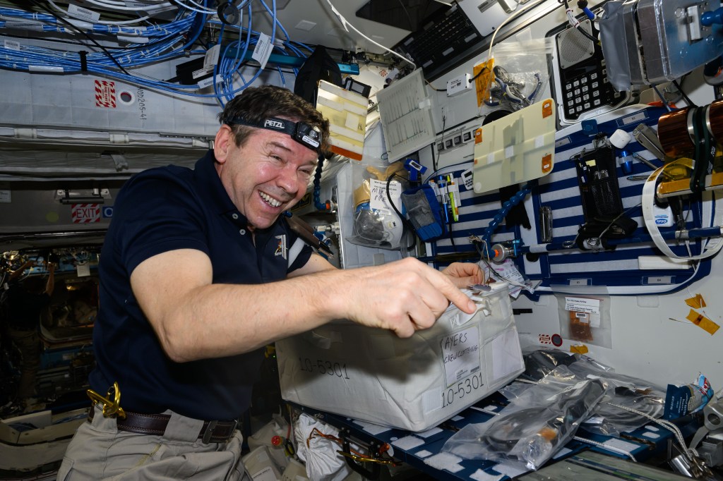 NASA astronaut and Expedition 71 Flight Engineer Mike Barratt transfers cargo bags delivered aboard the Northrop Grumman Cygnus space freighter into the International Space Station's Harmony module.