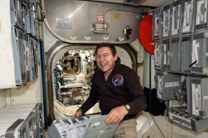 NASA astronaut and Expedition 71 Flight Engineer Mike Barratt checks food packs in the Unity module's galley aboard the International Space Station.