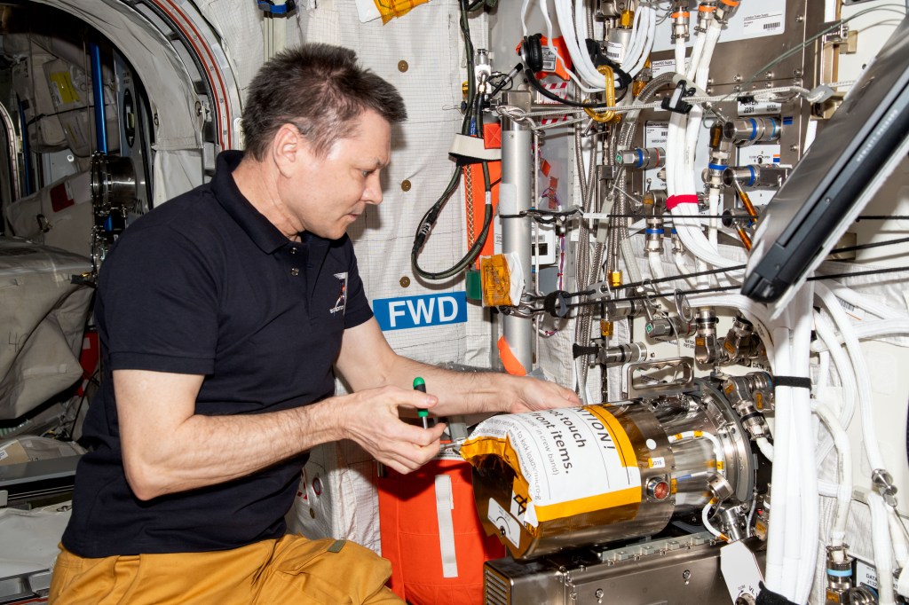 Roscosmos cosmonaut and Expedition 71 Commander Oleg Kononenko swaps sample chambers inside the Electromagnetic Levitator (EML) located aboard the International Space Station's Columbus laboratory module. The EML is a physics research device that measures the thermophysical properties of liquid metallic alloys at high temperatures.