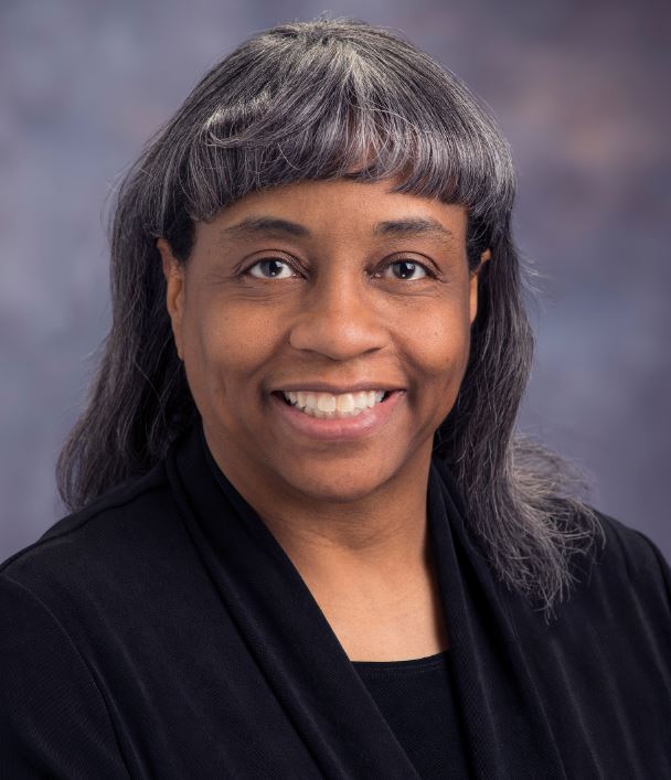 This is an official photograph of Sharon Monica Jones, Deputy Director of the Aeronautics Research Directorate at NASA’s Langley Research Center. Jones is wearing a red blouse.
