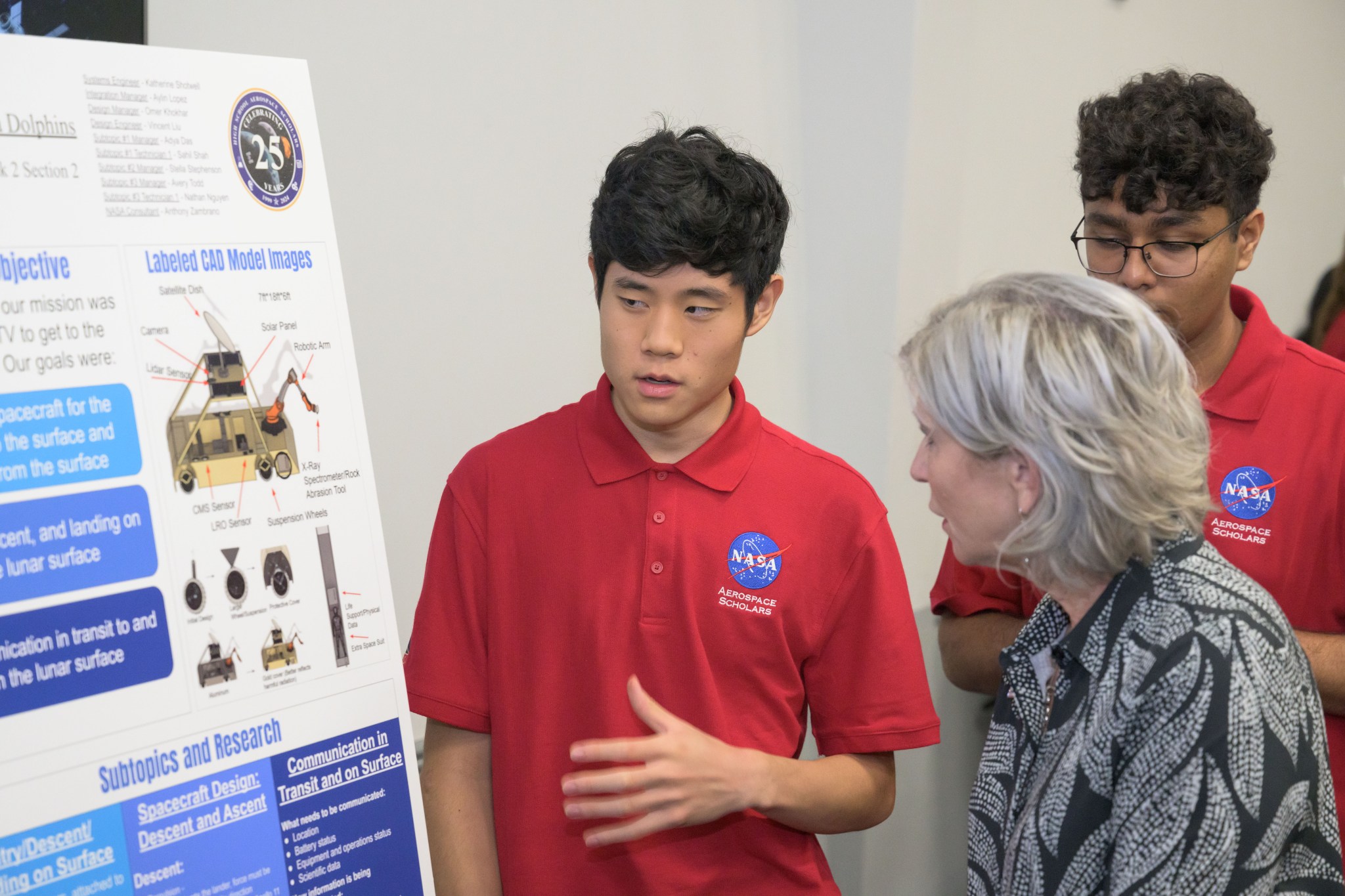 A High School Aerospace Scholar presents a project during a poster session.