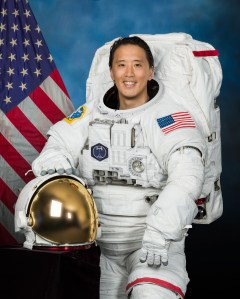 Official portrait of NASA astronaut Jonny Kim posing in a spacesuit at NASA's Johnson Space Center.