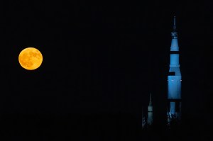 A super blue moon is to the left of the replica Saturn V at the US Space and Rocket Center in Huntsville, Alabama.
