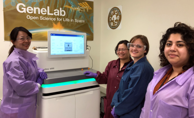scientists standing near a sequencing instrument