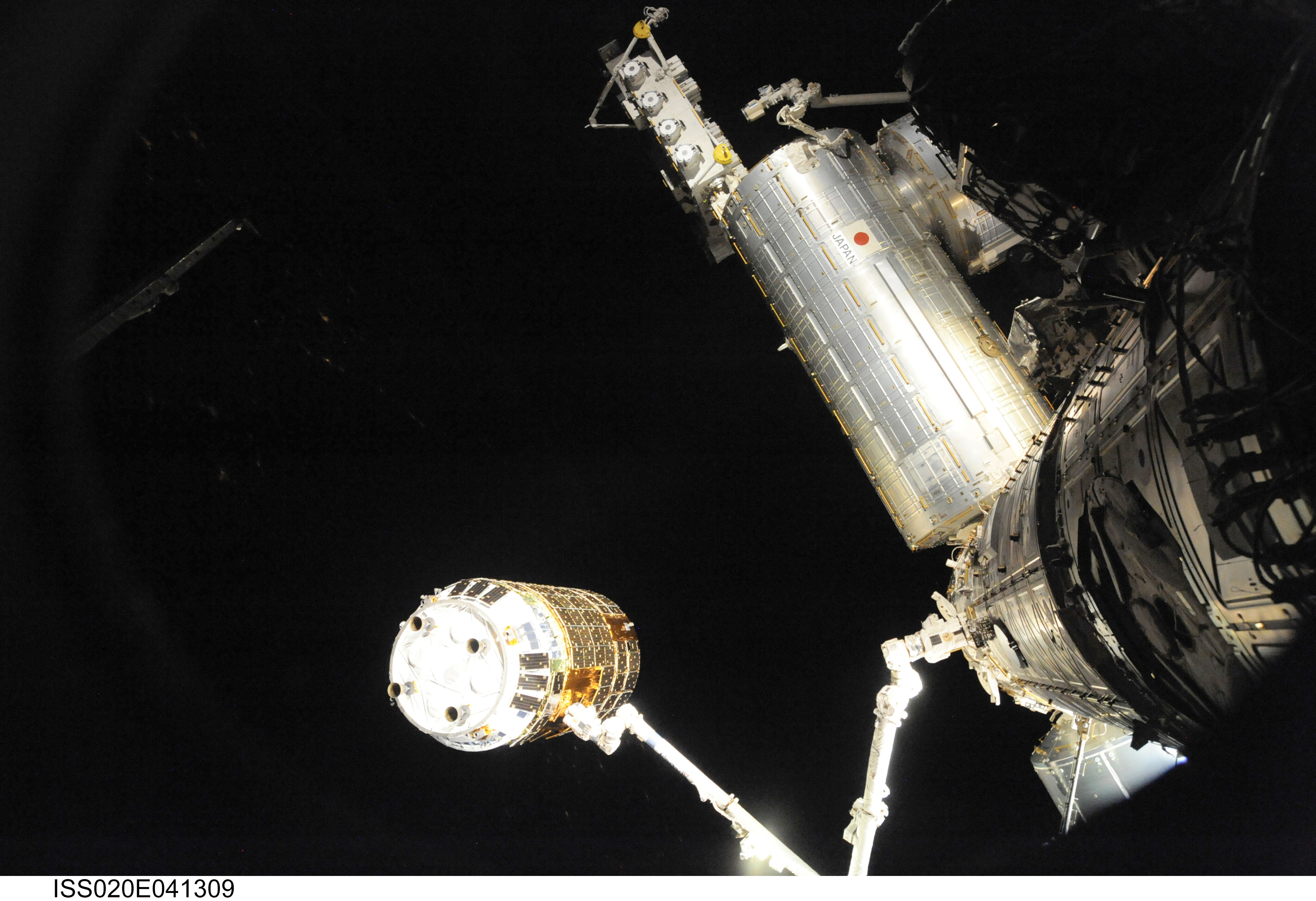 The Canadarm2 robotic arm grapples the Japanese H-II Transfer Vehicle (HTV) before installing the HTV to the Harmony module's Earth-facing port on ...