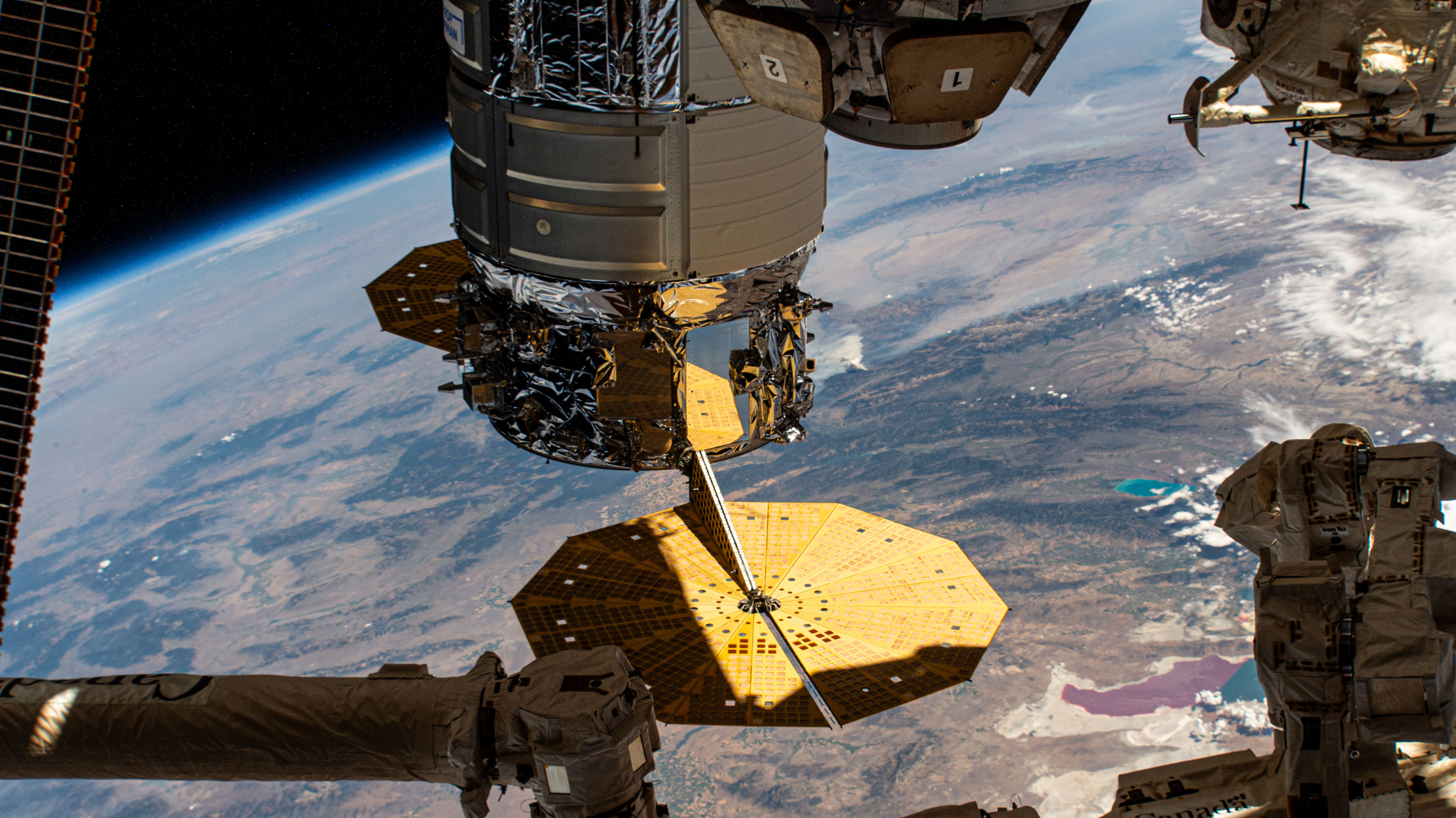 Northrop Grumman's Cygnus space freighter is pictured berthed to the International Space Station's Earth-facing port on the Unity module. At lower right, is Utah's Great Salt Lake divided by a causeway that separates the lake into two colors, red and green, due to different types of algae grwoing on either side. The orbital outpost was soaring 260 miles above the southwestern United States at the time of this photograph.