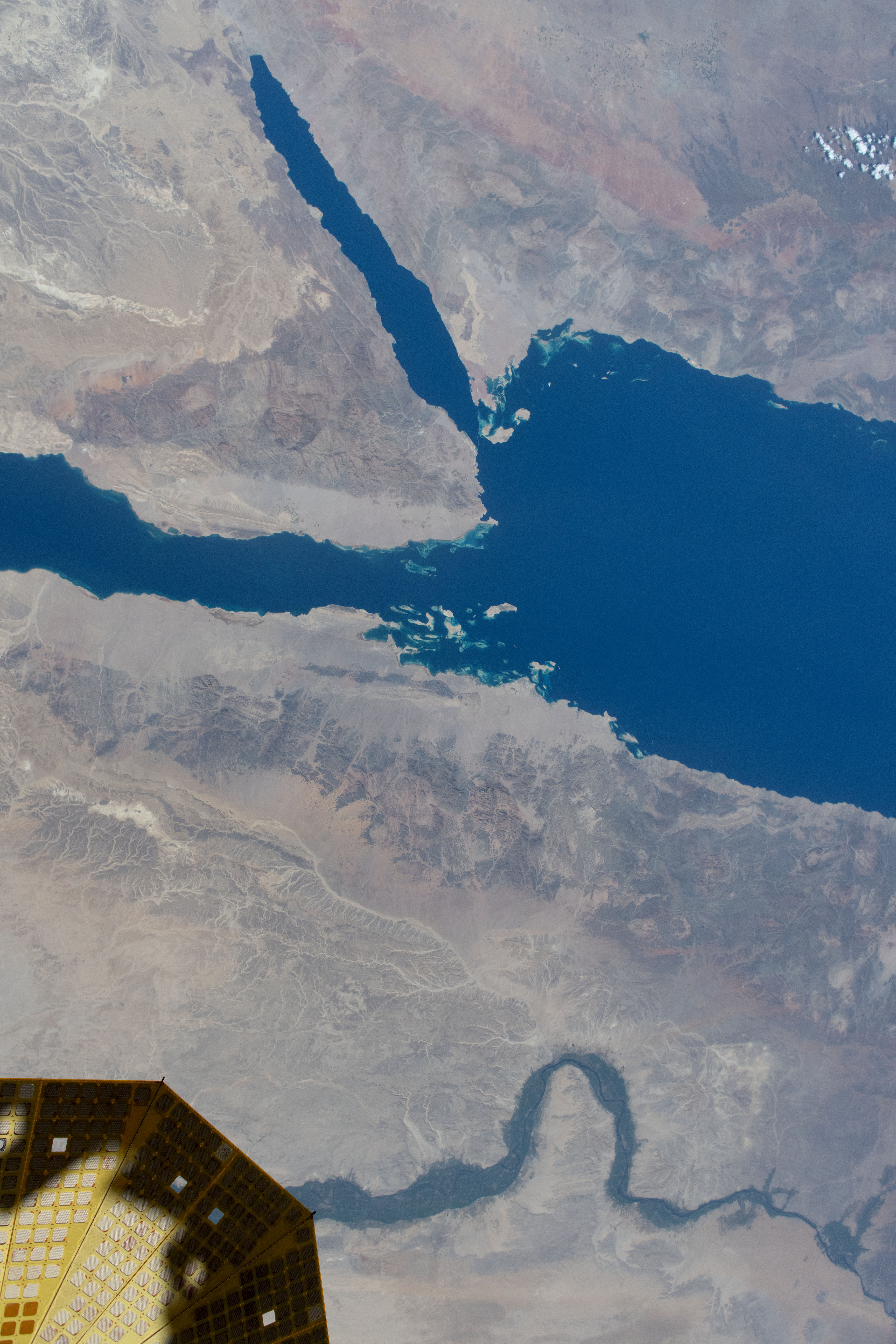 The Nile River runs alongside the Red Sea in this photograph from the International Space Station as it orbited 258 miles above the Middle East. At lower left, is one of the two cymbal-shaped UltraFlex solar arrays that power the Northrop Grumman space freighter.