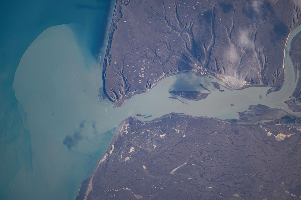 The Santa Cruz River, in Argentina's southernmost province, empties into the Argentine Sea in this photograph from the International Space Station as it orbited 267 miles above the South American nation's coast.