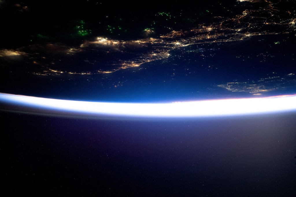 The city lights of southern Thailand and Malaysia sit in between the Malacca Strait (top) and the Gulf of Thailand with the southern coast of Vietnam, at bottom right, revealed by Ho Chi Minh City's night lights. Fishing boats, lit by LED green lights that attract plankton luring squid for catching, are pictured in both bodies of water in this orbital nighttime photograph from the International Space Station as it soared 261 miles above into a sunrise.