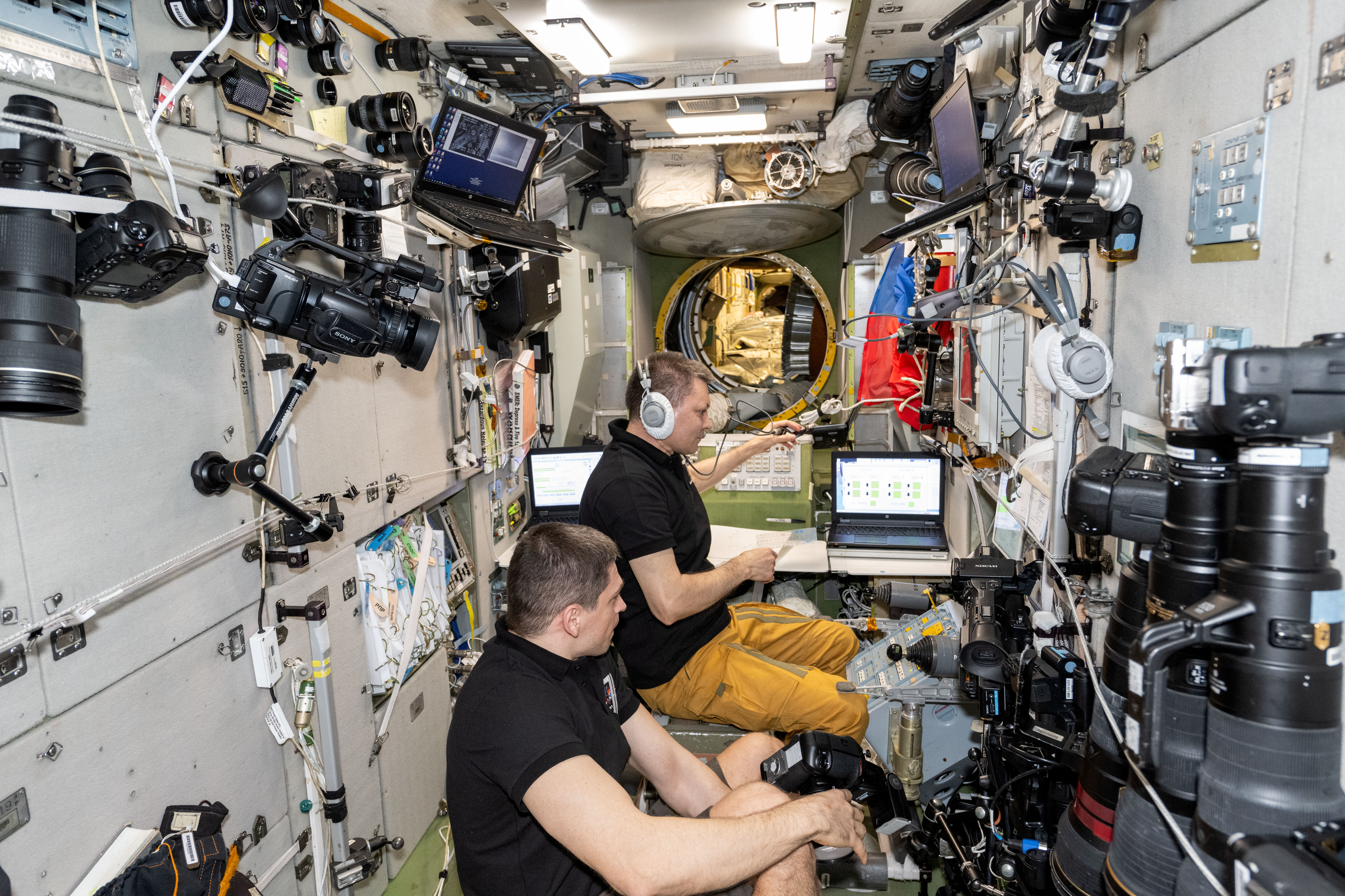 Roscosmos cosmonauts Nikolai Chub (foreground) and Oleg Kononenko, Expedition 71 Flight Engineer and Commander respectively, are at the controls of the telerobotically operated rendezvous unit, or TORU, monitoring the automated rendezvous and docking of the Progress 89 cargo craft. Located inside the International Space Station's Zvezda service module, the TORU can be used to remotely control the Roscosmos spaceship in the unlikely event it would be unable to complete its automated docking.