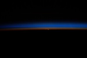iss071e609208 (Sept. 4, 2024) -- The Moon rises through a sunset in Earth's horizon casting blue and orange hues as the International Space Station orbited 257 miles above India.