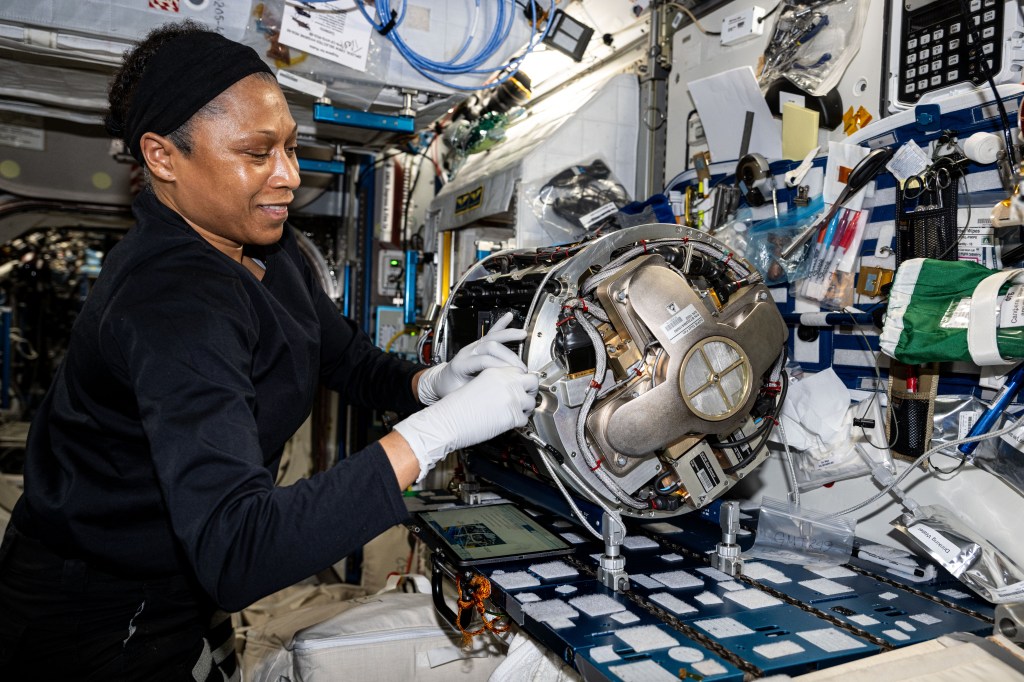 NASA astronaut and Expedition 71 Flight Engineer Jeanette Epps swaps research components and removes samples from inside the Combustion Integrated Rack for a series of experiments exploring space flammability and fire suppression in microgravity.