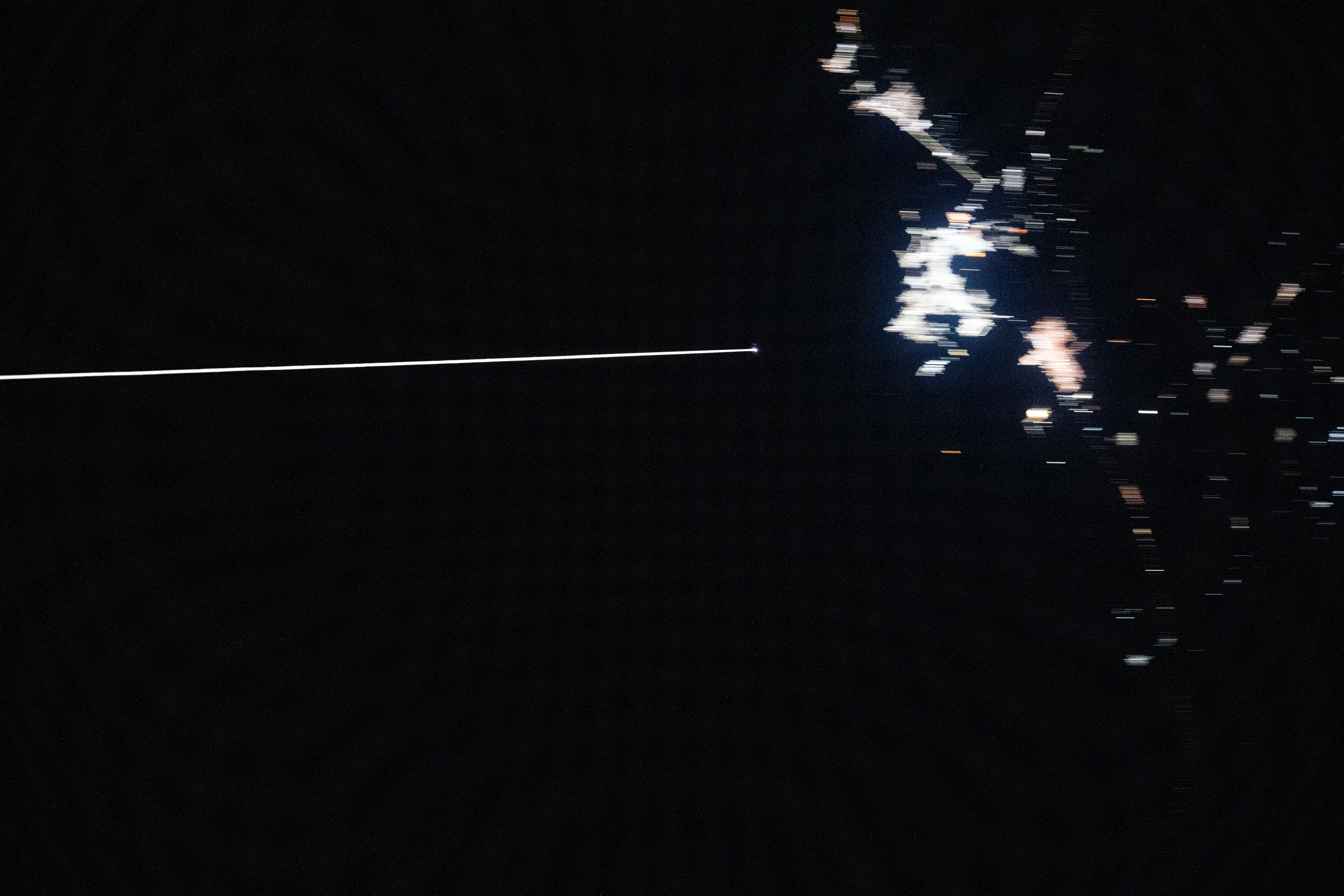 Boeing's uncrewed Starliner spacecraft is pictured from the International Space Station reentering Earth's atmosphere and creating a plasma trail with its heat shield 259 miles above the Mexican state of Chihuahua. Starliner would parachute to a landing at White Sands Space Harbor in New Mexico several minutes later.