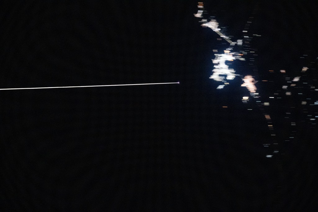 Boeing's uncrewed Starliner spacecraft is pictured from the International Space Station reentering Earth's atmosphere and creating a plasma trail with its heat shield 259 miles above the Mexican state of Chihuahua. Starliner would parachute to a landing at White Sands Space Harbor in New Mexico several minutes later.