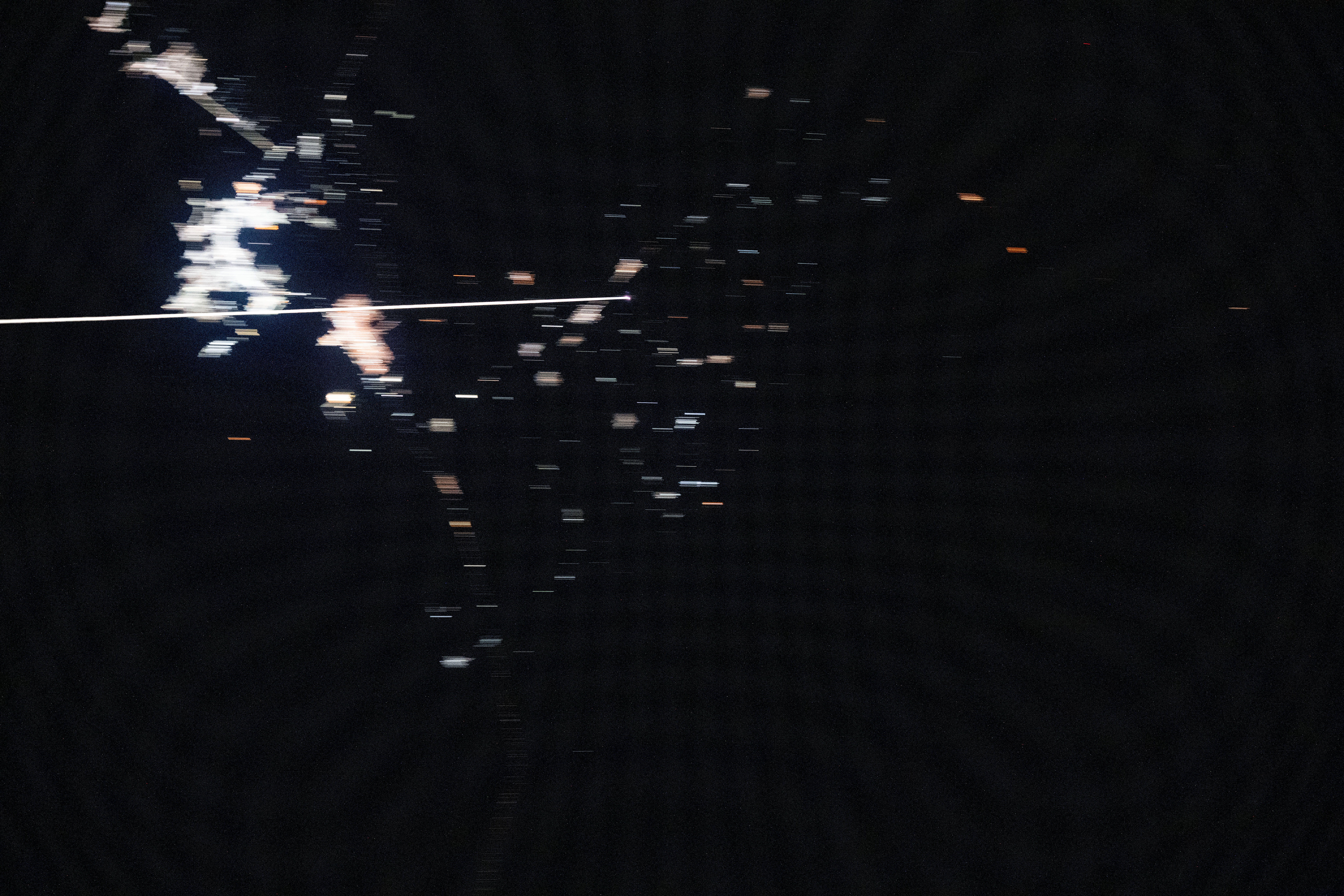 Boeing's uncrewed Starliner spacecraft is pictured from the International Space Station reentering Earth's atmosphere and creating a plasma trail with its heat shield 259 miles above the Mexican state of Chihuahua. Starliner would parachute to a landing at White Sands Space Harbor in New Mexico several minutes later.