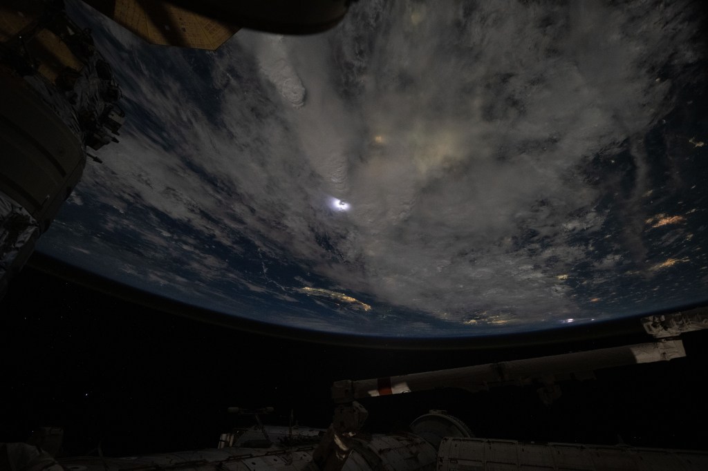 Lightning (at center) illuminates the storm clouds above China near the coast of the Taiwan Strait in this photograph from the International Space Station as it orbited 261 miles above the Asian nation.