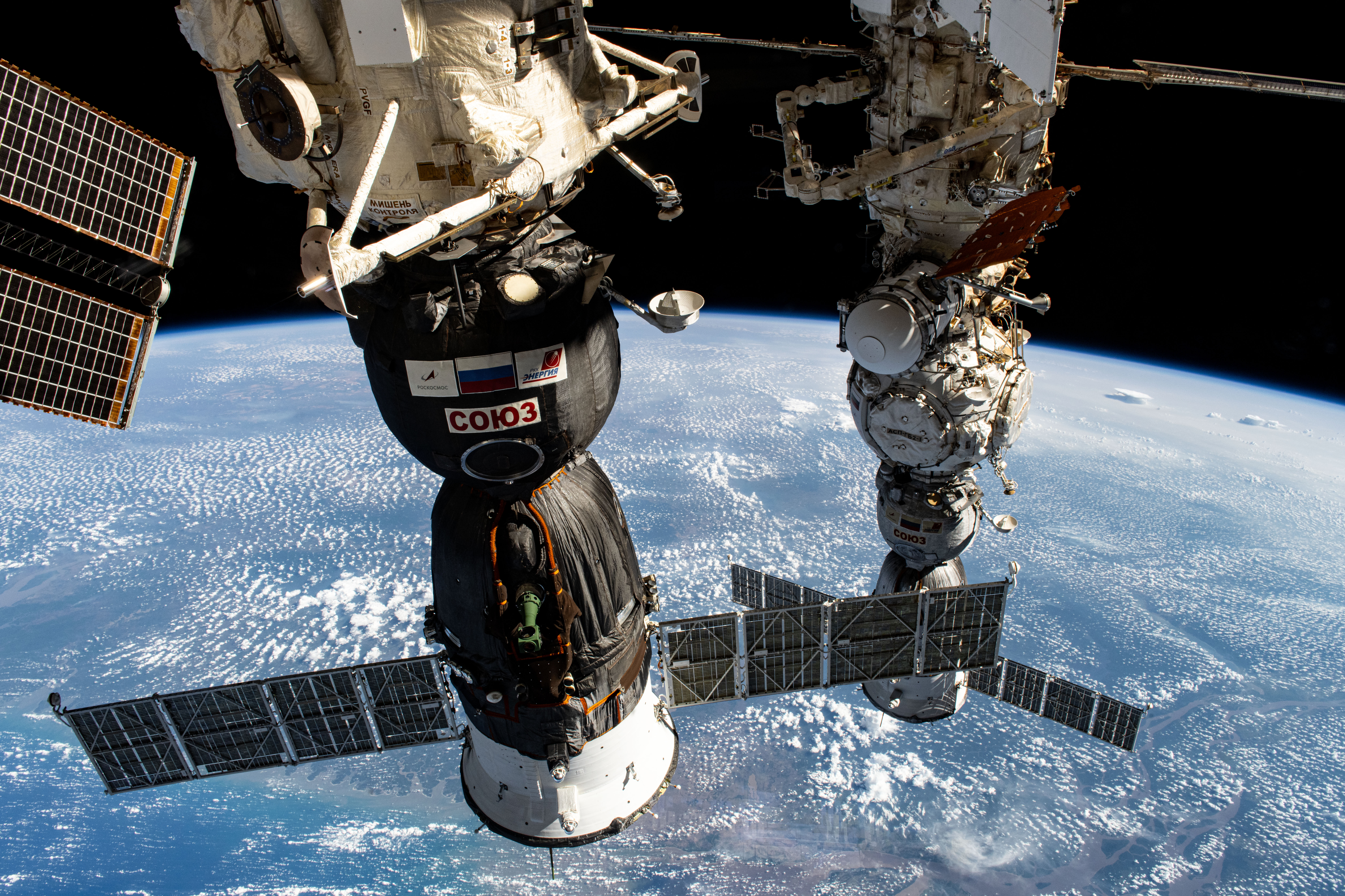 Two Roscosmos crew ships, the Soyuz MS-26 docked to the Rassvet module (foreground) and the Soyuz MS-25 (background) docked to the Prichal docking module, are pictured parked at the International Space Station as it orbited 257 miles above the Atlantic Ocean near Brazil's Amazon Delta.