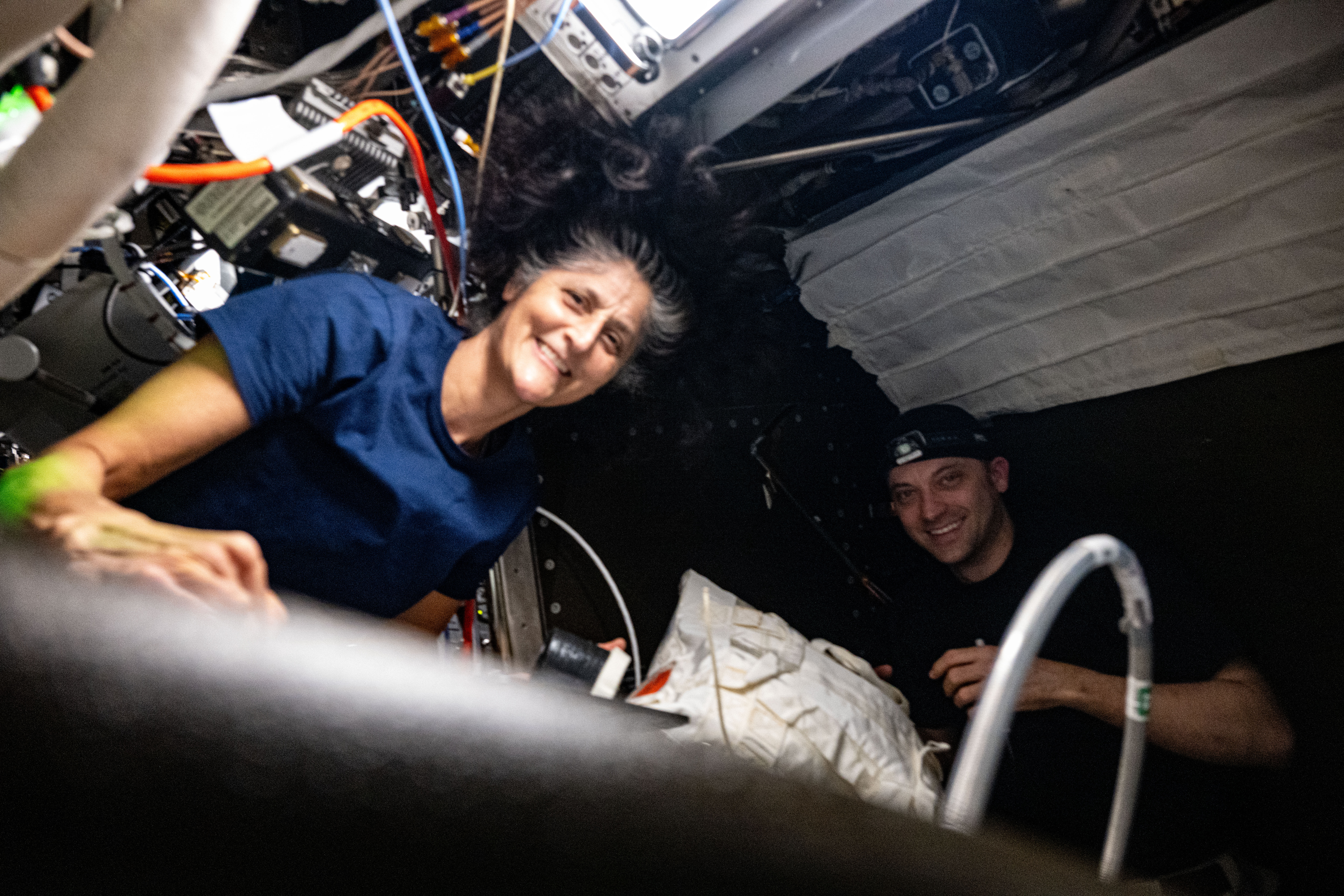 Expedition 71 Flight Engineers Suni Williams and Matthew Dominick, both from NASA, servicie an oxygen generator preparing it for upcoming parts replacement aboard the International Space Station's Destiny laboratory module.