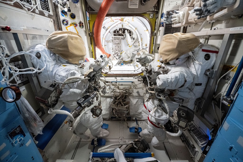 Two spacesuits, with the helmets covered for protection, are staged inside the International Space Station's Quest airlock in preparation for spacewalk that NASA astronauts Suni Williams and Butch Wilmore conducted on Jan. 30, 2025.