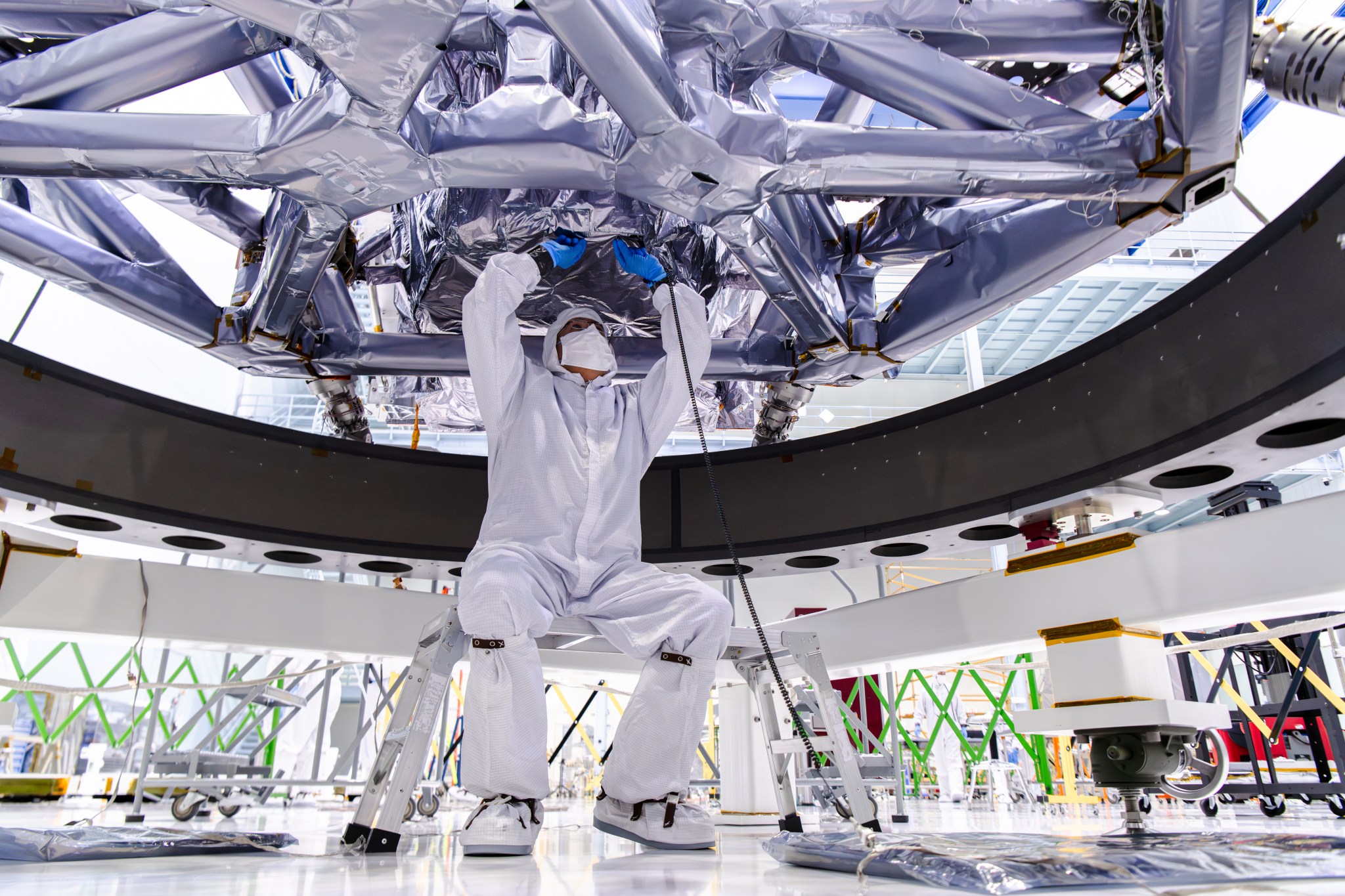 A clean room technician works on the Roman Coronagraph.