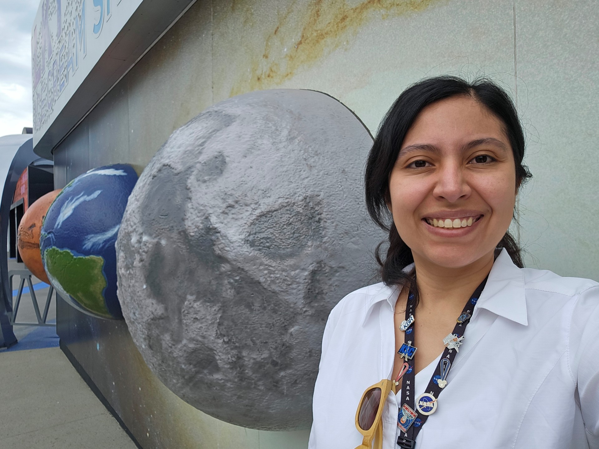 Selfie photo of Ames Research Center's America Reyes Wang. She stand in front of a planetarium.