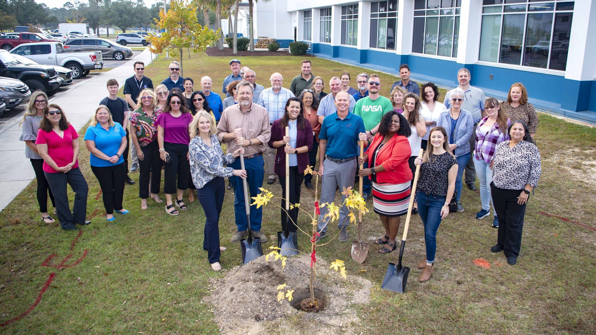Employees of NASA Stennis and the NASA Shared Services Center gather outside to plant an Artemis Moon Tree