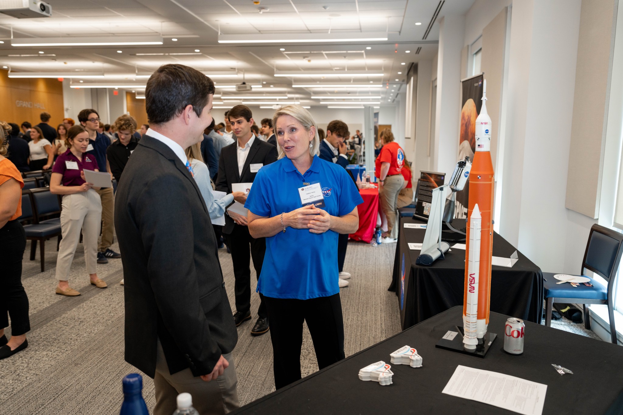 Heather Haney, center, test and verification subsystem manager in the Space Launch System Program Office at NASA’s Marshall Space Flight Center, discusses aerospace career options with Auburn University faculty and students during Aerospace Industry Day events.