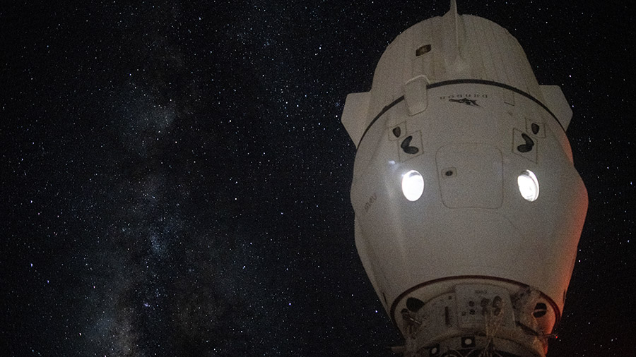 The Milky Way appears in the vastness of space behind the SpaceX Dragon Endeavour spacecraft docked to the space station's Harmony module.