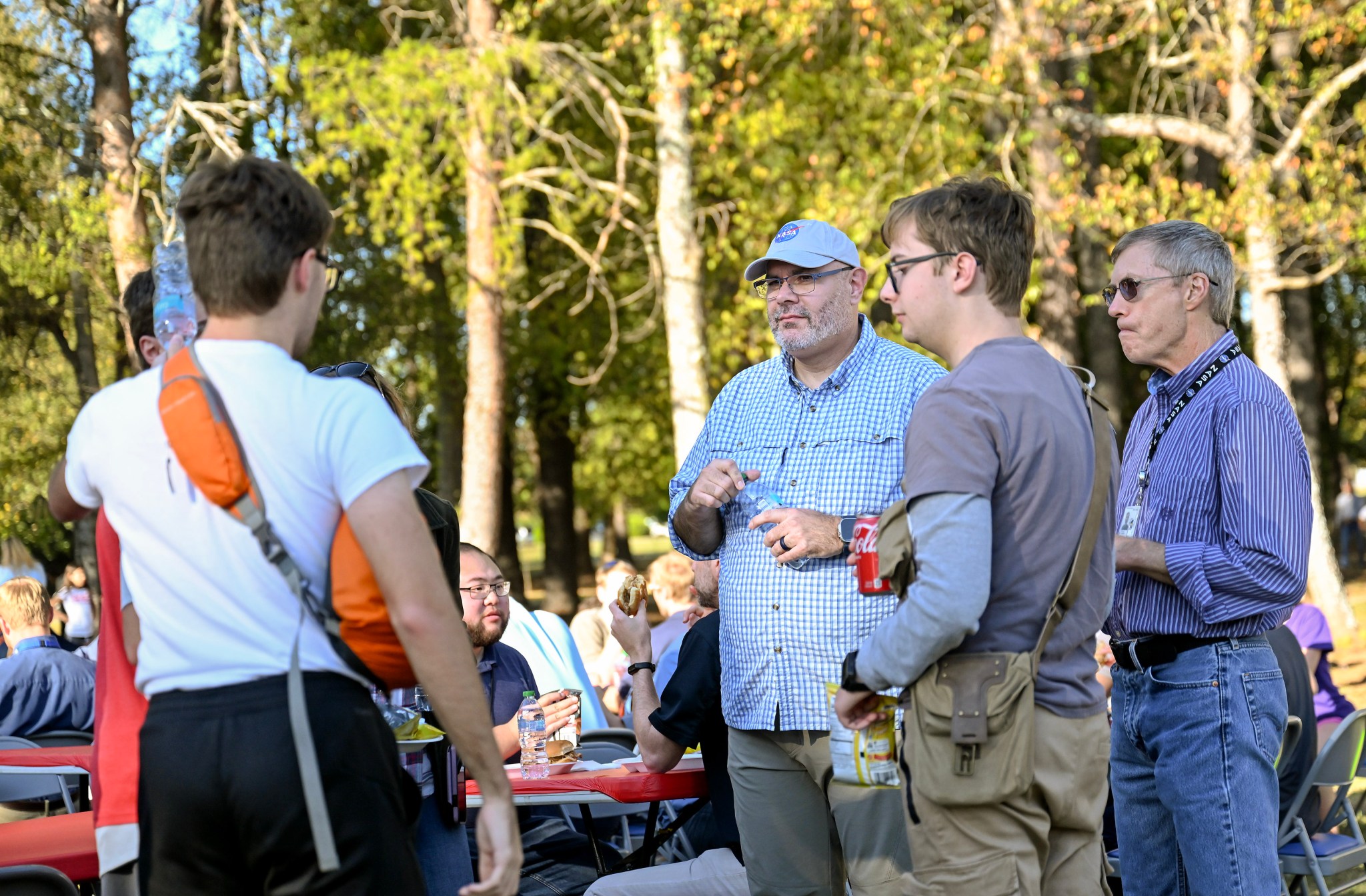 Joseph Pelfrey, center, director of NASA’s Marshall Space Flight Center, talks with team members during the BBQ Fest hosted by the Marshall Exchange on Oct. 21. The event was held on the walking trail behind the Wellness Center and was open to team members, their family members, and retirees. "My thanks to those who came out to this year's BBQ – and especially to those who helped make it happen,” Pelfrey said. “I could not have asked for better weather or a better group of people to spend the afternoon with. It was great to see everyone's families join us on site to celebrate the hard work our teams have put in this year.”