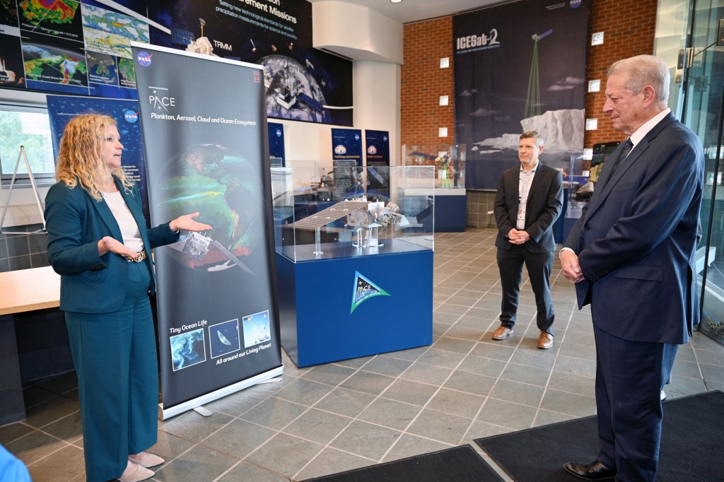 Christa Peters-Lidard, NASA Goddard's Sciences and Exploration Directorate director (left), speaks with Gore in the lobby of Building 32, where the former vice president viewed the control room of NASA's Plankton, Aerosol, Cloud, ocean Ecosystem (PACE) mission.
