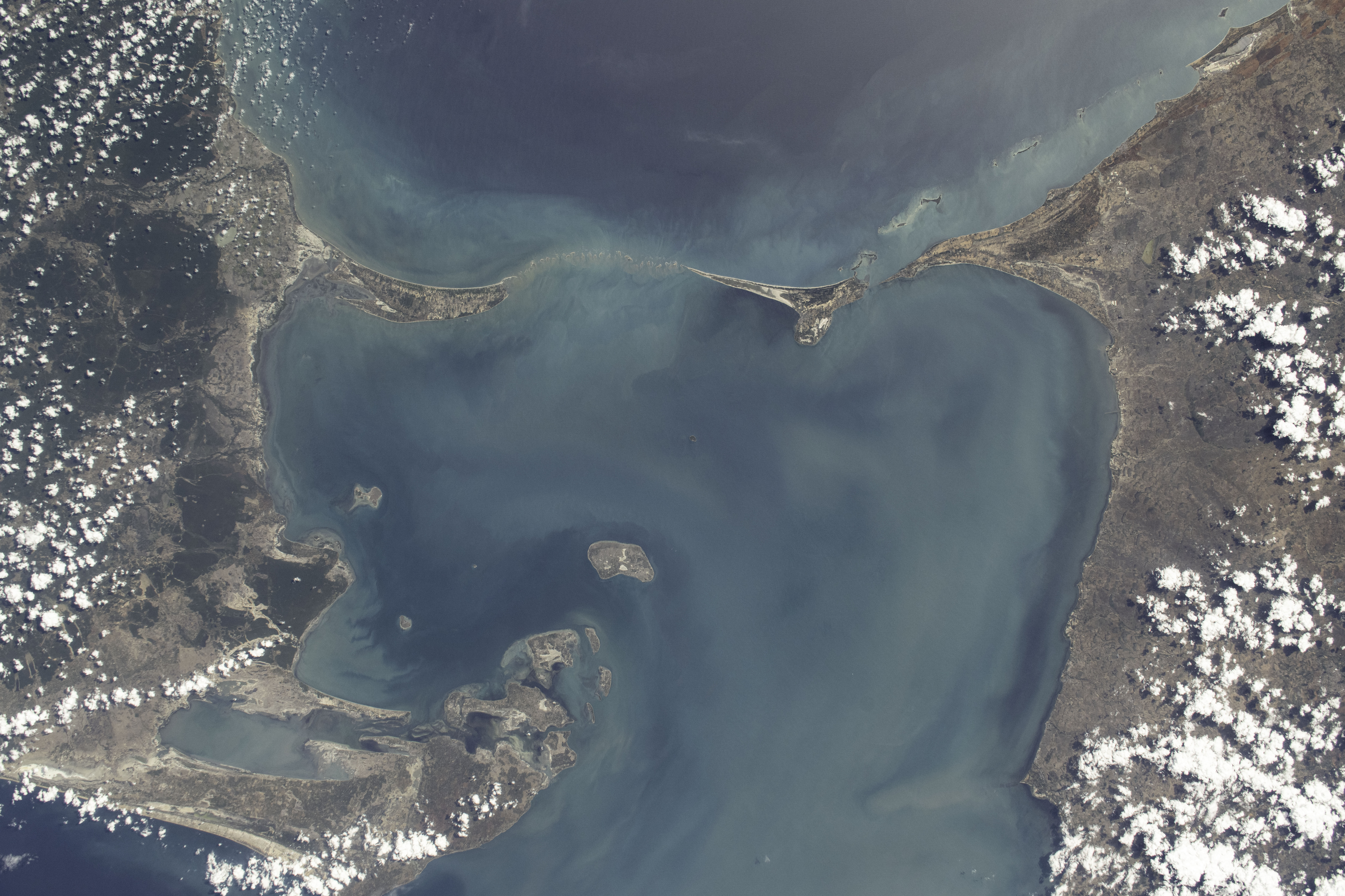 iss071e700080 (Sept. 21, 2024) -- A 48 kilometer ( 30 miles) chain of limestone shoals, formerly a bridge between India and Sri Lanka, are pictured from the International Space Station as it orbited 256 miles above. Most often called "Adam's Bridge," it separates the Palk Strait (bottom of image) from the Gulf of Mannar (top). To the right of this image is mainland India, to the left is Sri Lanka.