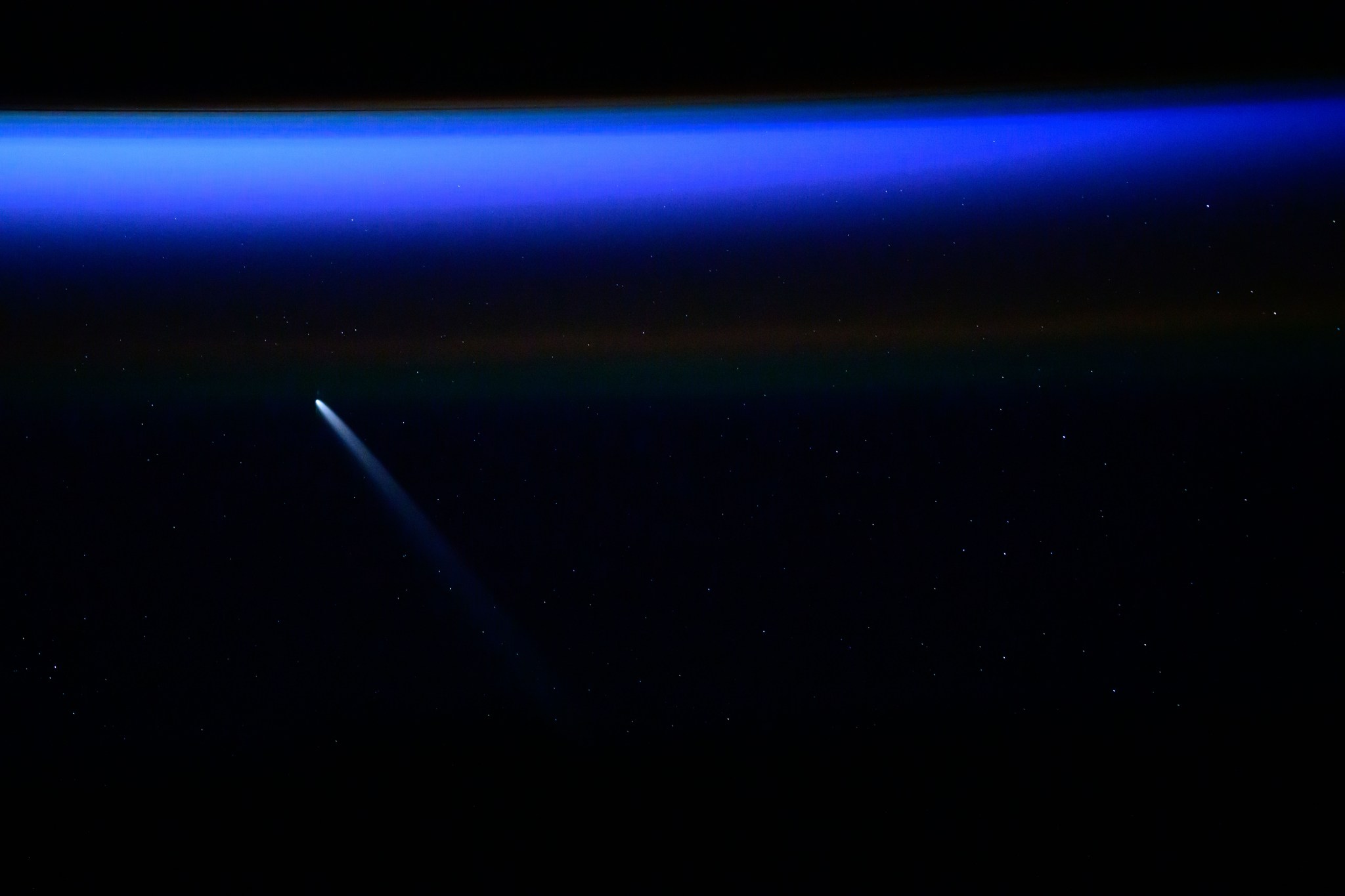 Dark background of the sky with bright blue Comet C/2023 A3 (Tsuchinshan-ATLAS), roughly 44 million miles away from Earth at the time of this photo, was pictured from the International Space Station as it orbited 271 miles above the South Atlantic Ocean.