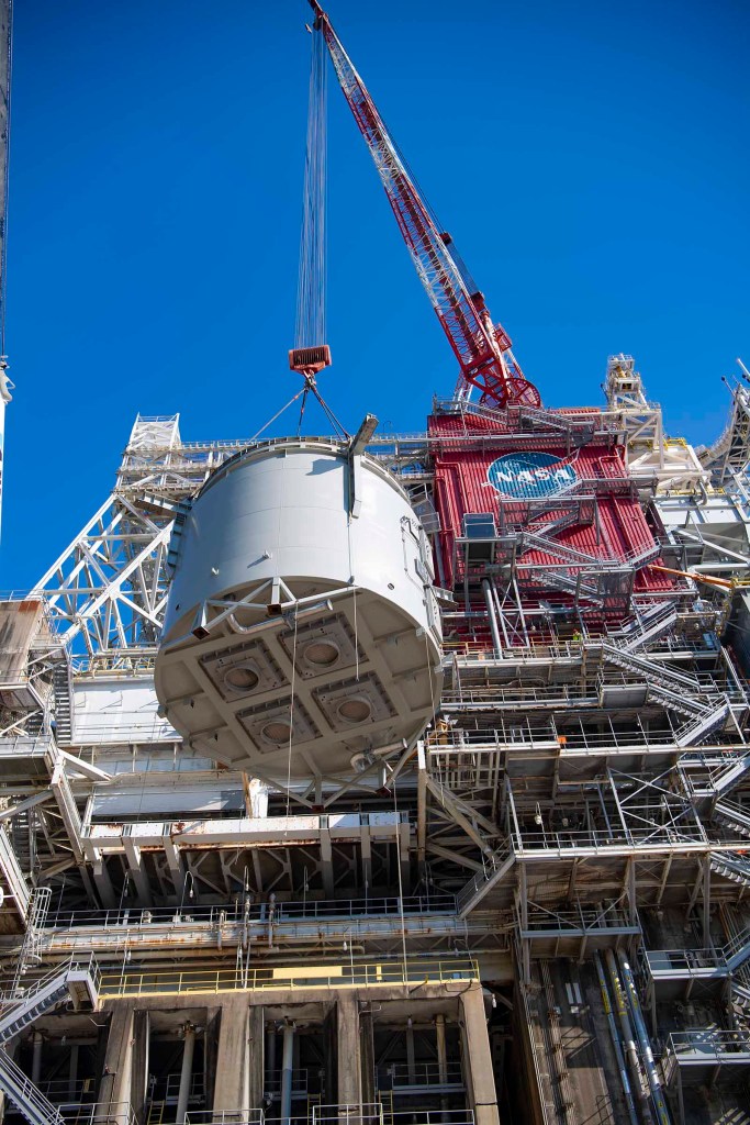interstage simulator component suspended in air by crane