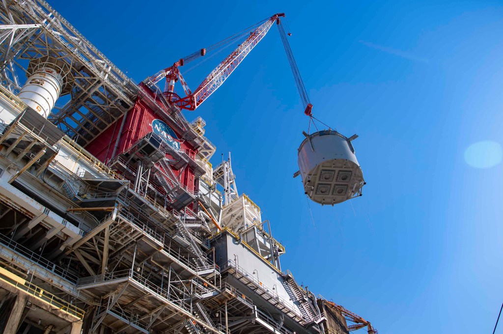 interstage simulator component suspended in air by crane