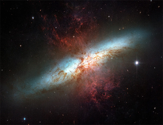Plumes of glowing hydrogen blast from the center of M82, a well known galaxy undergoing a torrent of star formation. This mosaic of six images taken in 2006 by the Hubble Space Telescope is the sharpest ever obtained of the entire galaxy.