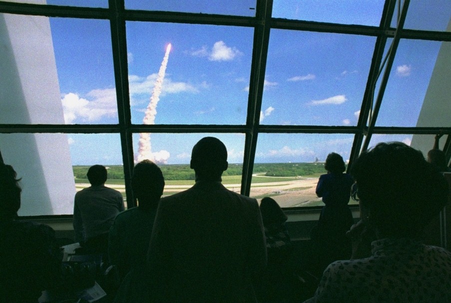 Controllers in the Firing Room watch Atlantis take to the skies