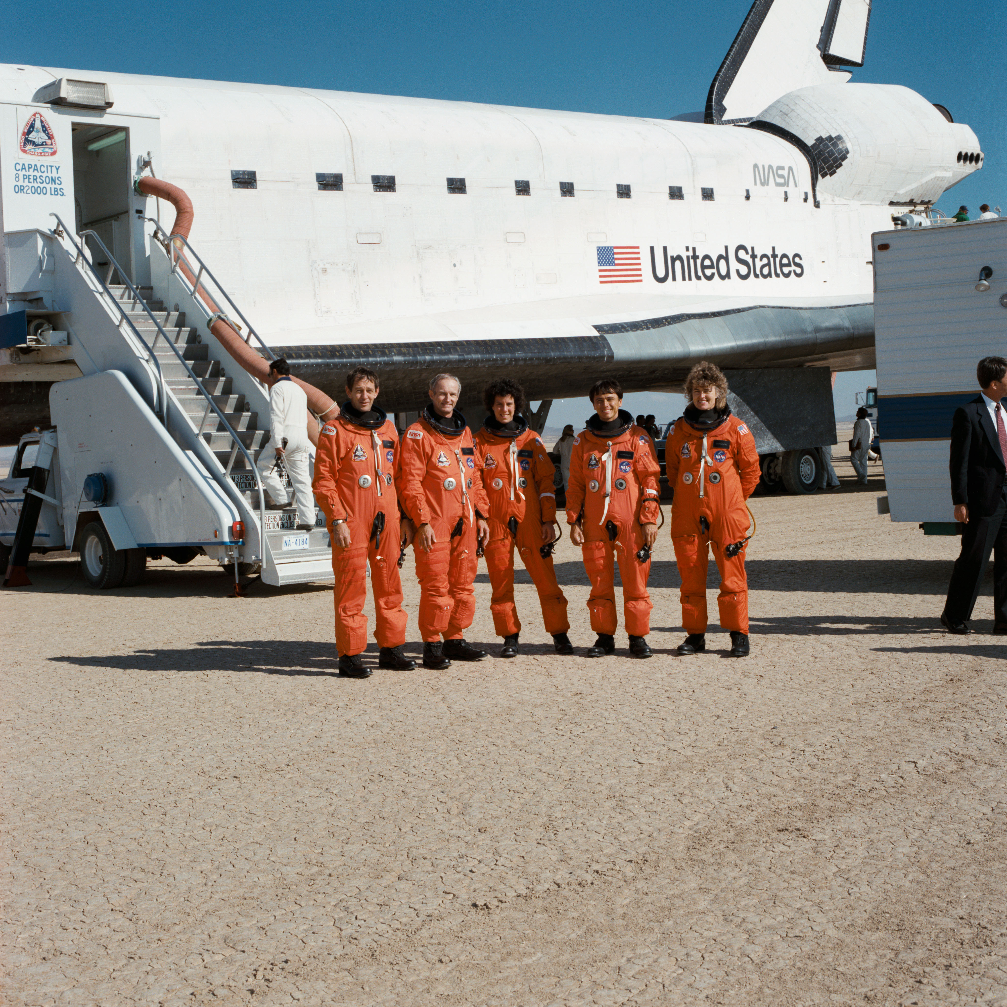 The STS-34 astronauts pose in front of Atlantis