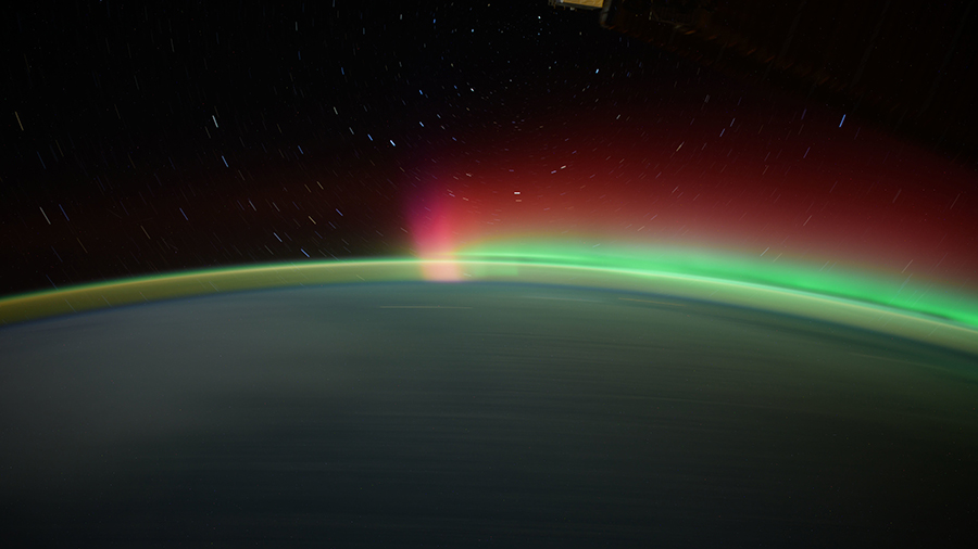 Star trails, an aurora, and Earth's atmospheric glow highlight this long-duration photograph taken from the International Space Station as it orbited 259 miles above the North Pacific Ocean.