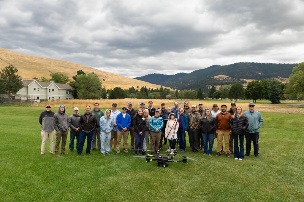 Teams from NASA FireSense, NASA Langley, NASA Ames, MITRE, Esri, Salish Kootenai College, and the University of Idaho gather for a group photo around the NASA Alta X quadcopter during the 2024 FireSense uncrewed aerial system (UAS) technology demonstration in Missoula, Montana.